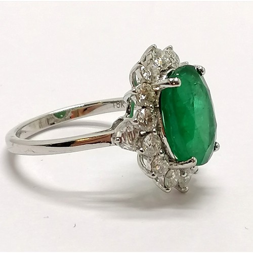 209 - 18ct marked white gold emerald (approx 11.5mm x 8.5mm) & diamond cluster ring with diamond trapezium... 