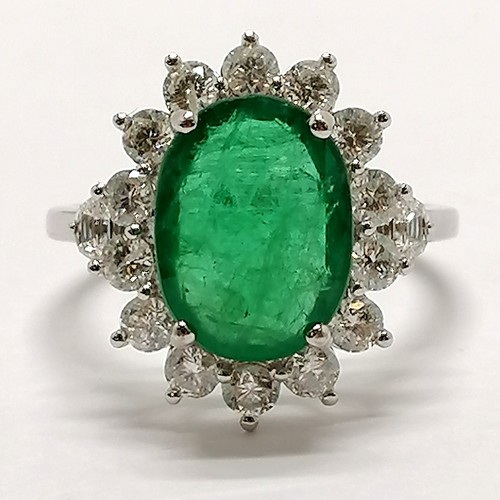 209 - 18ct marked white gold emerald (approx 11.5mm x 8.5mm) & diamond cluster ring with diamond trapezium... 