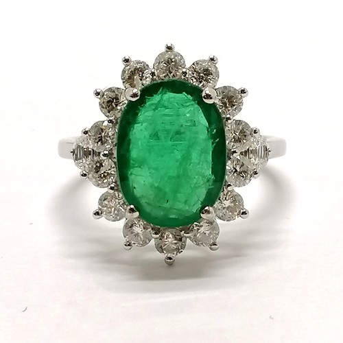 209 - 18ct marked white gold emerald (approx 11.5mm x 8.5mm) & diamond cluster ring with diamond trapezium... 