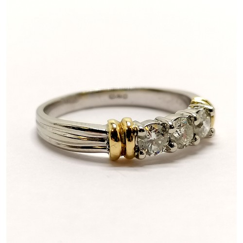 230 - 18ct marked white gold 3 stone diamond (approx 3.2mm diameter) ring with yellow gold detail to shoul... 