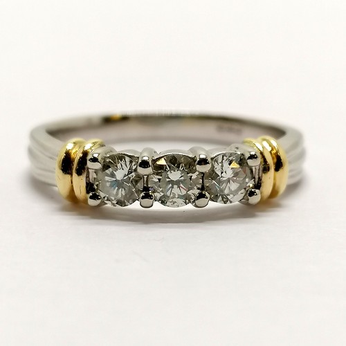 230 - 18ct marked white gold 3 stone diamond (approx 3.2mm diameter) ring with yellow gold detail to shoul... 