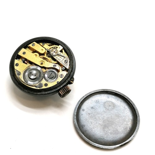 285 - Antique gun metal buttonhole/lapel watch with green enamel decoration 3cm diameter. in original reta... 