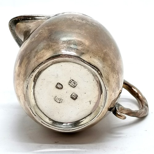 292 - Antique silver cream jug hallmarked London 1808. 90g, 8.5cm high. Has dents to the body and base