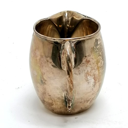 292 - Antique silver cream jug hallmarked London 1808. 90g, 8.5cm high. Has dents to the body and base