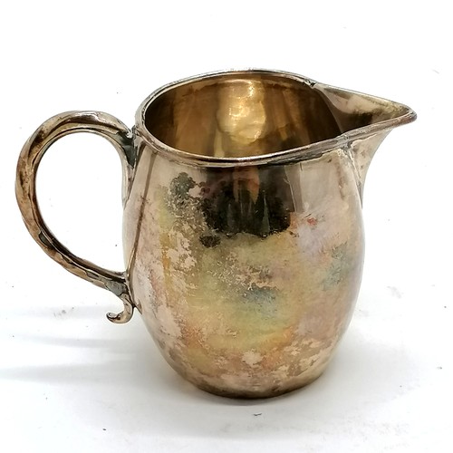 292 - Antique silver cream jug hallmarked London 1808. 90g, 8.5cm high. Has dents to the body and base