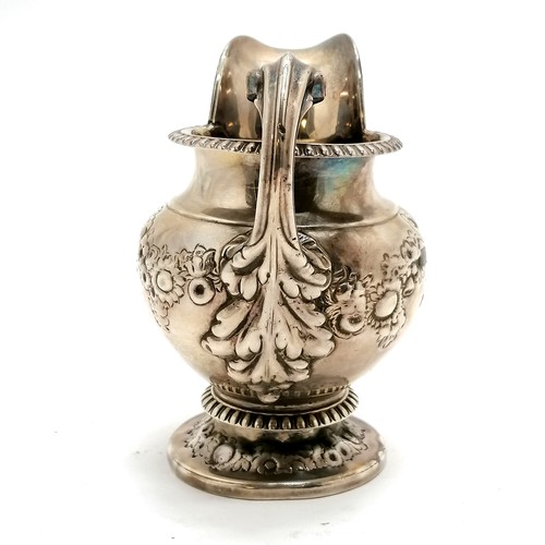 293 - Antique silver embossed cream jug hallmarked London 1812. 240g. 8cm high. fractures to both sides of... 