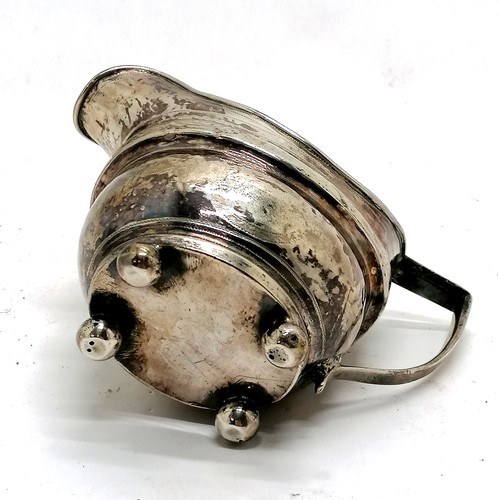 294 - Antique silver cream jug, Exeter hallmarked with chased decoration on 4 bun feet. 9.5cm high. 106g. ... 