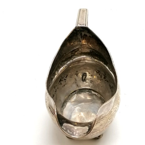 294 - Antique silver cream jug, Exeter hallmarked with chased decoration on 4 bun feet. 9.5cm high. 106g. ... 