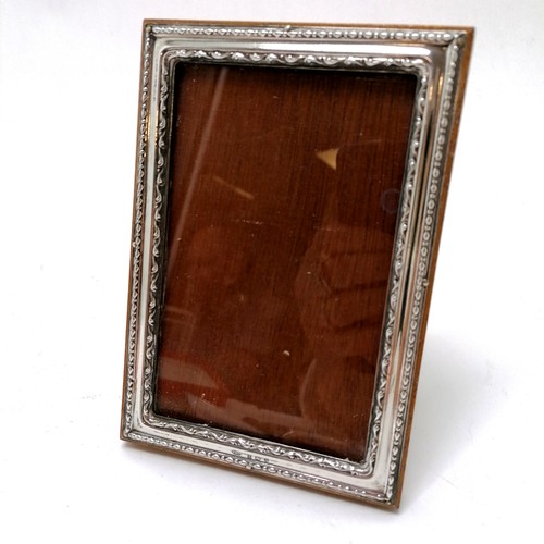 756 - Silver wooden backed picture frame (14cm x 10cm) t/w silver spoon, tongs, 2 silver pronged mother of... 