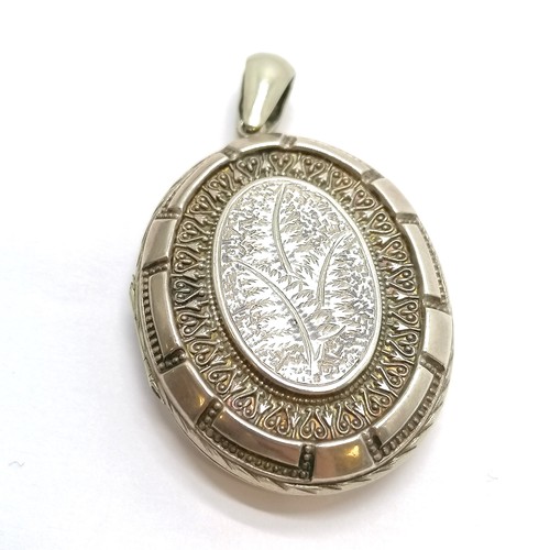 451 - Unmarked antique silver locket pendant with engraved fern decoration - 6cm & 18.8g & in good used co... 