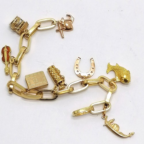 457 - 18ct gold charm bracelet with 8 charms i) 9ct faith/hope/charity ii) 9ct Chim opening well iii) 18ct... 