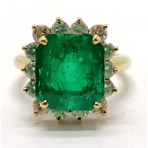 459 - 18ct marked gold emerald & diamond cluster ring - size M½ & 7.1g total weight ~ the emerald is appro... 