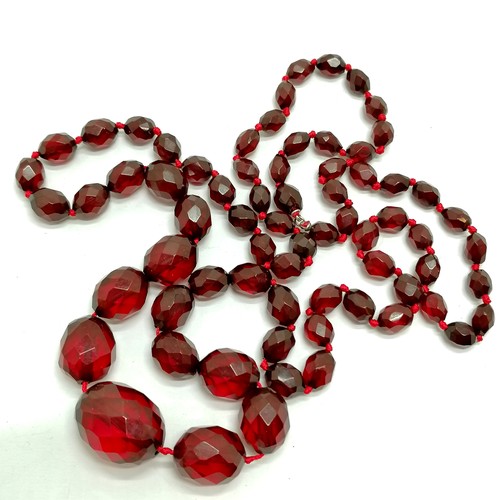 603 - Strand of cherry amber bakelite facetted beads - 86cm & 50g total weight