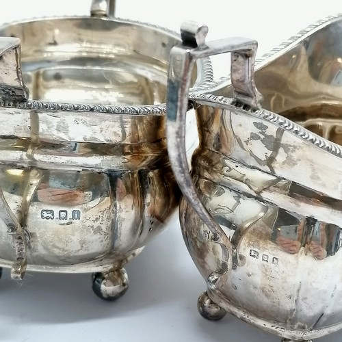 821 - Matched pair of silver cream & sugar with gadrooned edge & terminating on ball feet by C S Harris & ... 