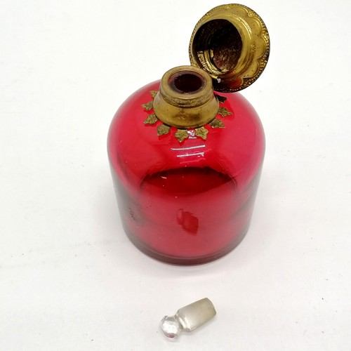 19 - Antique cranberry glass scent bottle with gilt metal hinged lid with porcelain floral plaque to cent... 