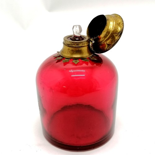 19 - Antique cranberry glass scent bottle with gilt metal hinged lid with porcelain floral plaque to cent... 