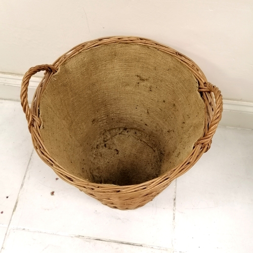 52 - Wicker log basket with hessian lining. 55cm high x 50cm diameter. In good used condition.