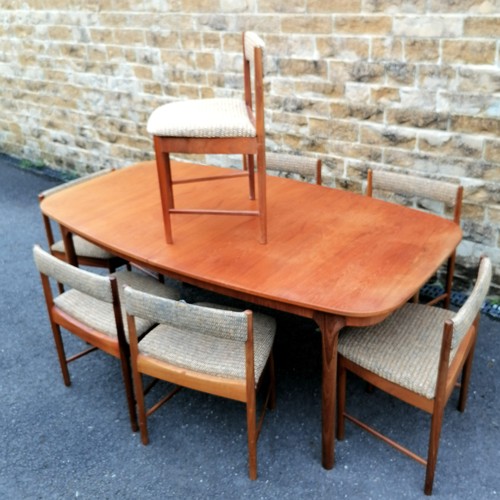 68 - A H McIntosh & Co Ltd., Kirkcaldy teak extending dining table t/w 7 dining chairs. 180 cms length un... 