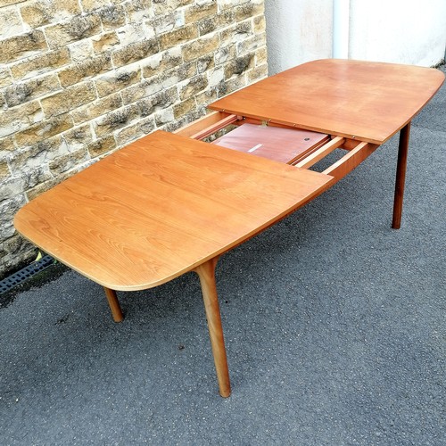 68 - A H McIntosh & Co Ltd., Kirkcaldy teak extending dining table t/w 7 dining chairs. 180 cms length un... 