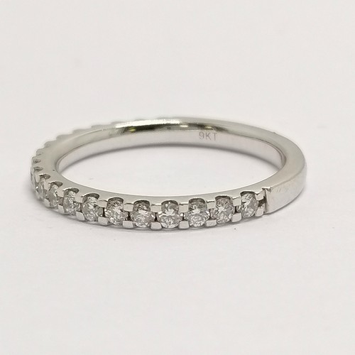 677 - 9ct hallmarked white gold diamond (20) set eternity ring - size O & 2.4g total weight