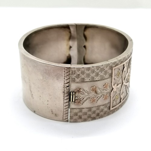 712 - Antique unmarked silver and gold bangle, interior diameter 5cm, 2.8cm wide, in overall good used con... 