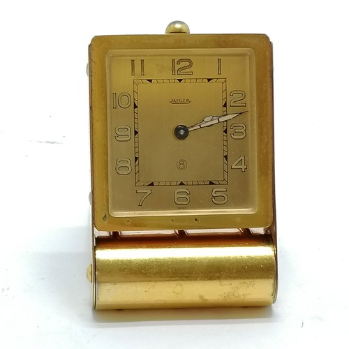 784 - Art Deco Jaeger 8-day travel clock in gilt metal - 8cm x 5.5cm - for spares / repairs