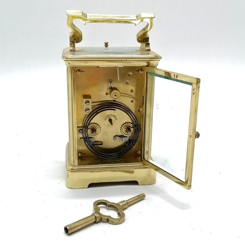 789 - Antique brass carriage clock with bell strike mechanism and key - total height (inc handle) 18cm