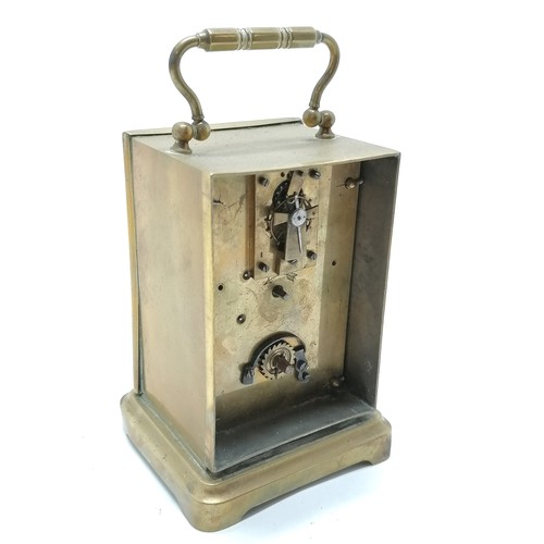 790 - Brass anniversary clock with ceramic dial 15cm high- Missing it's back and crack to dial