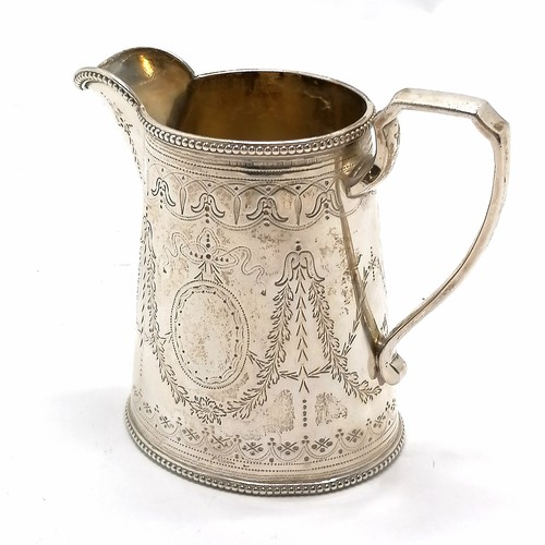 836 - Victorian silver cream / milk jug - 11cm high & 201g and has a lion crest. In good used condition