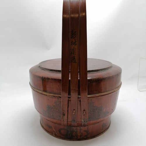 34 - Chinese rice carrier with metal hanging loop and paint decoration to lid and sides and has writing o... 