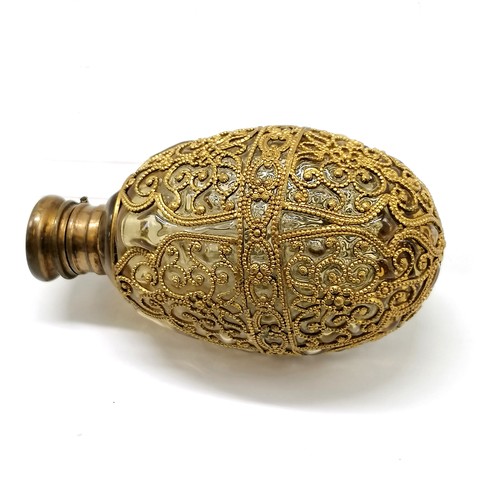 102 - Antique hand blown scent bottle, with gilded filigree metal decoration, 10 cms length, 6 cms width, ... 