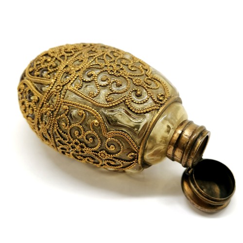 102 - Antique hand blown scent bottle, with gilded filigree metal decoration, 10 cms length, 6 cms width, ... 