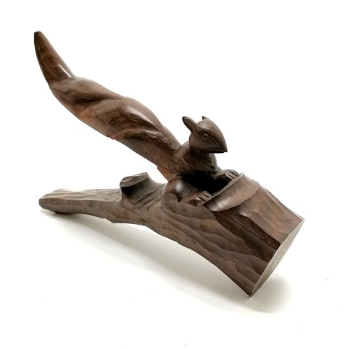 114 - Hand carved hard wood nut cracker in the form of a squirrel. 21cm long. As found to 1 ear