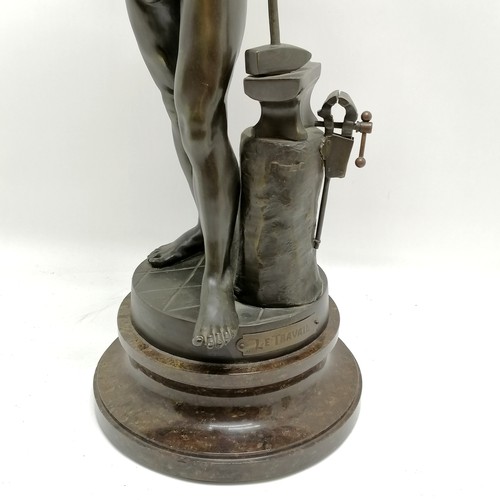 223 - Antique spelter study of a blacksmith titled 'Le Travail' (work) - 64cm high and is on a turned marb... 