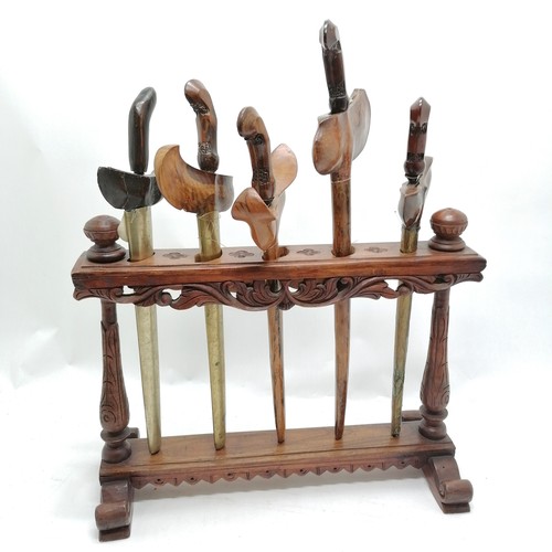 236 - 5 antique Javanese Kris on a hand carved display stand 49cm wide x 40cm high - Some have old repairs