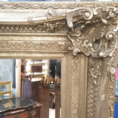 255 - Large scale silver gilded ornate framed bevelled mirror - 160cm x 130cm.