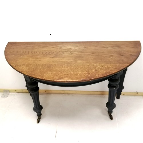 260 - Antique oak blue painted demi lune table with bras castors 31cm wide x 63cm deep x 73cm high. In goo... 