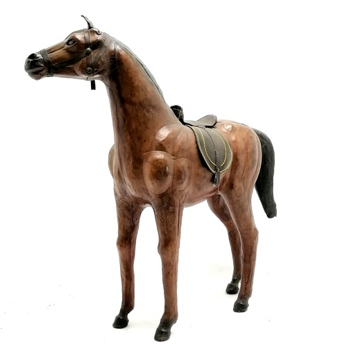 268 - Vintage leather horse with saddle and glass eyes. 49cm high x 48 long in overall good used condition... 