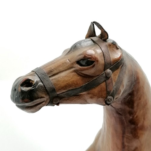 268 - Vintage leather horse with saddle and glass eyes. 49cm high x 48 long in overall good used condition... 