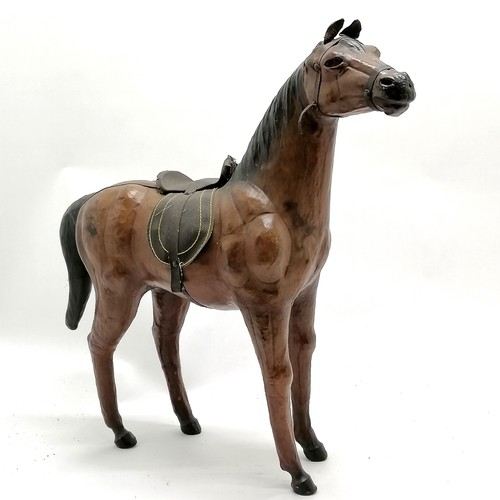 268 - Vintage leather horse with saddle and glass eyes. 49cm high x 48 long in overall good used condition... 