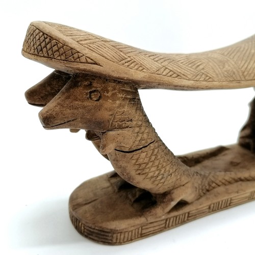 273 - Carved wooden tribal double headrest with 2 kneeling figures and 4 crocodiles. 38cm x 13cm. Some spl... 