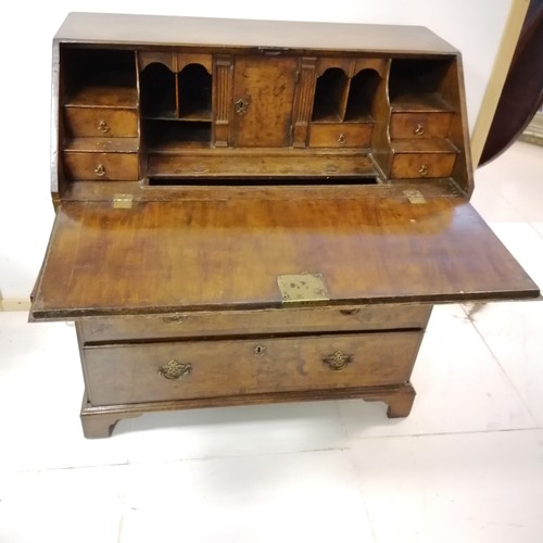 331 - An Antique walnut fall front bureau, revealing pigeon hole interior, and secret drawers, on 2 short ... 