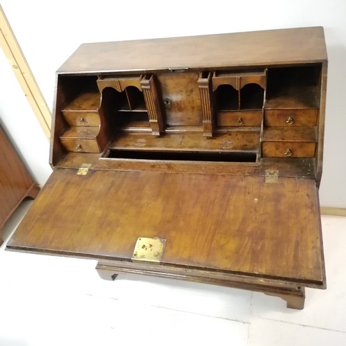 331 - An Antique walnut fall front bureau, revealing pigeon hole interior, and secret drawers, on 2 short ... 