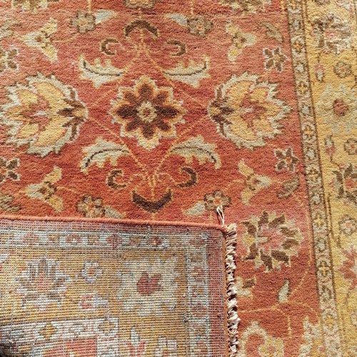 447 - Indian pale yellow and terracotta coloured wool rug - 250cm x 150cm ~ in good used condition