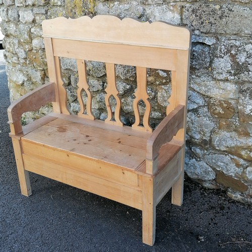 466 - Continental pine hall settle with storage compartment to the seat. 110cm x 102cm x 42cm. In overall ... 