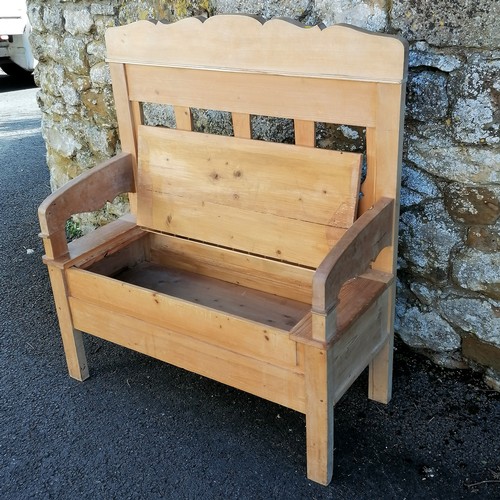 466 - Continental pine hall settle with storage compartment to the seat. 110cm x 102cm x 42cm. In overall ... 