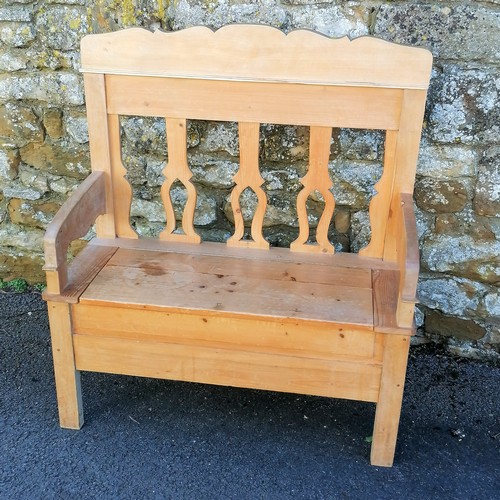 466 - Continental pine hall settle with storage compartment to the seat. 110cm x 102cm x 42cm. In overall ... 