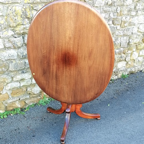 468 - Antique mahogany oval tilt top table. 105cm x 80cm across. Has fading to the top and small split oth... 