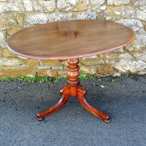 468 - Antique mahogany oval tilt top table. 105cm x 80cm across. Has fading to the top and small split oth... 