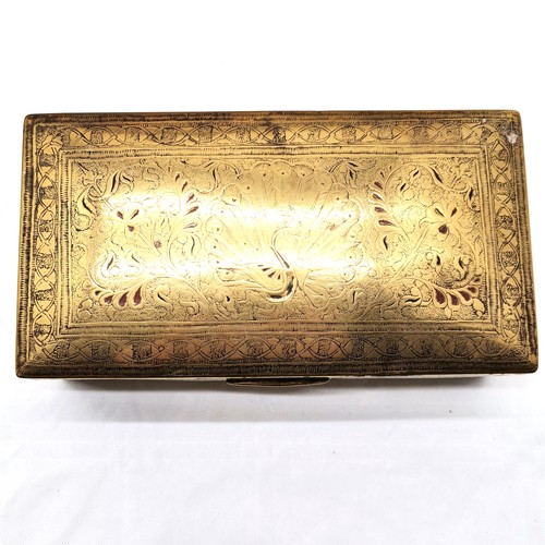 507 - A Brass oval tray, 68 cm x 52 cm t/w embossed tray, Indian brass cigarette box and a bell.